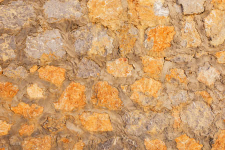 Ancient stone wall background with cement.