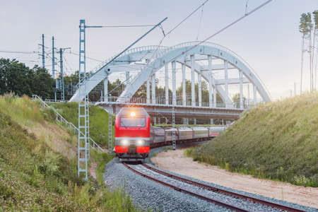 Passenger train moves under the bridge,の写真素材