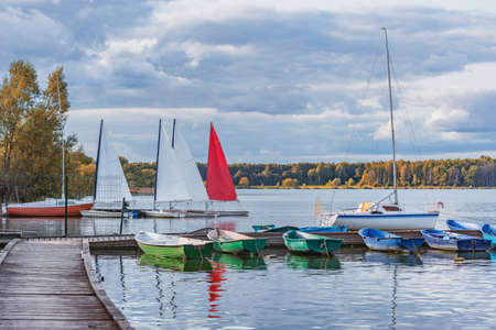 Boats by the pier. Lake view at summer day time.の写真素材