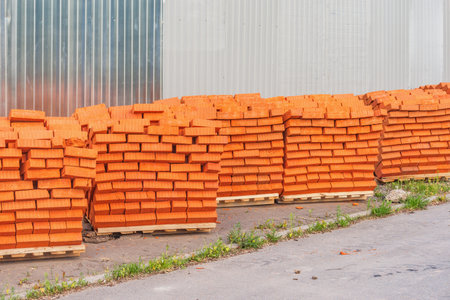 Red bricks by the construction site fence.の写真素材