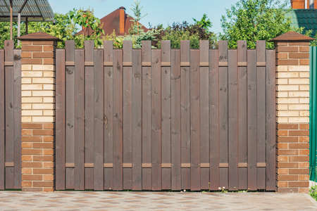 Metal fence by the private house at summer time.の写真素材