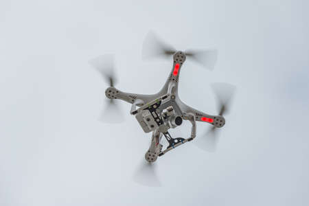 White quadrocopter in the sunset sky.の写真素材