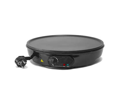 Electric frying pan for pancakes isolated on white background.の写真素材