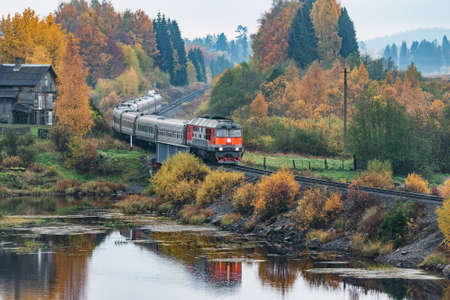 Passenger train at autumn cloudy morning.