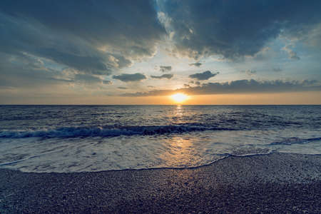 Sunset sky over the calm surface of the sea.の写真素材