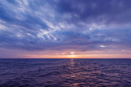 Sunset sky over the surface of the sea.の写真素材