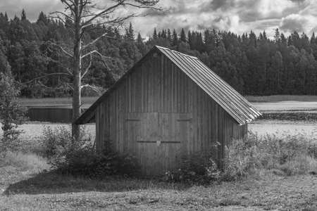 Ancient wooden house by the lake in the forest.の写真素材