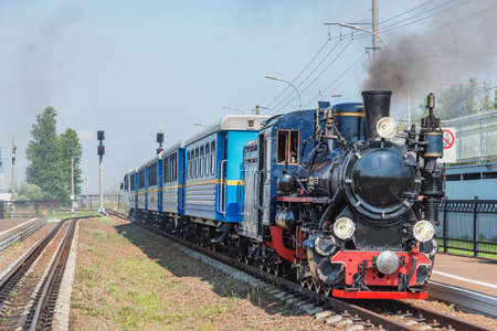 Steam train of Children's railway stands by the platform. Saint-Petersburg. Russia.の写真素材