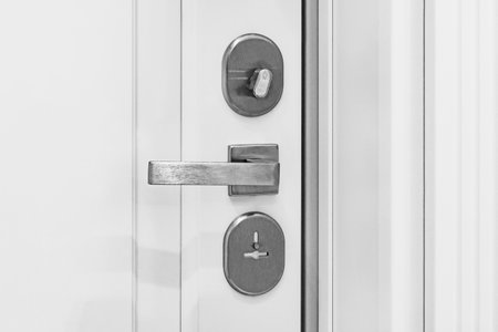 Closeup of metal doorhandle on wooden door.の写真素材
