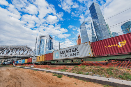 Moscow, Russia - August 16, 2015: Railway container train on the business city center background.のeditorial素材