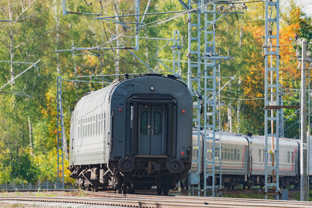 Passenger train moves at autumn morning time.の写真素材