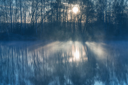 Sunrise above the lake at cold autumn morning.の写真素材