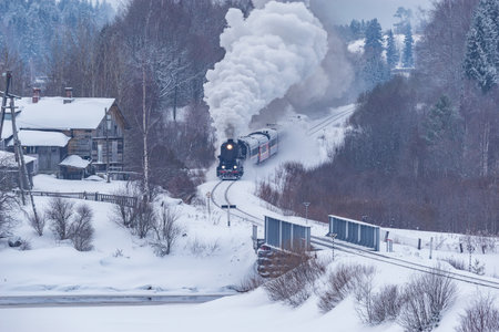 Retro steam train moves at winter day.の写真素材