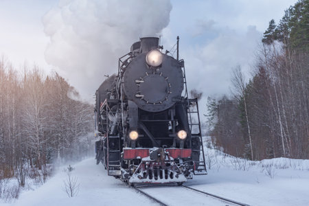 Retro steam train moves at winter day.の写真素材