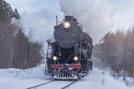 Retro steam train moves at winter day.の写真素材