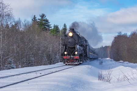 Retro steam train moves at winter day.の写真素材