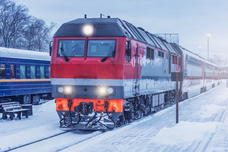 Passenger train stands by the platform before departure at winter morning.の写真素材
