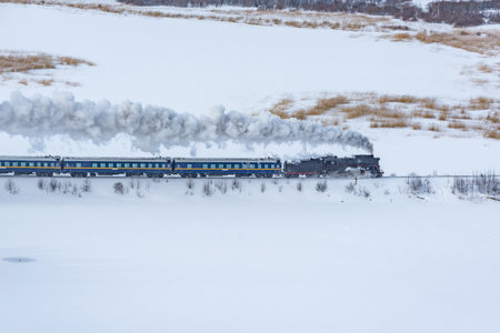 Retro steam train moves at winter morning time.の写真素材