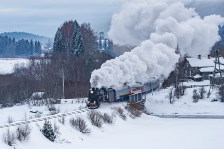 Retro steam train moves at winter morning time.の写真素材