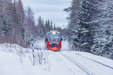 Passenger train moves fast at winter day.の写真素材