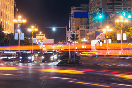 Car lights on the central city streets at evening timeの写真素材