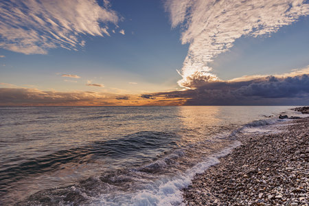 Amazing cloudscape above the sea at sunset time.の写真素材