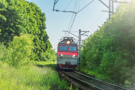 Freight train approaches the station at summer day.の写真素材