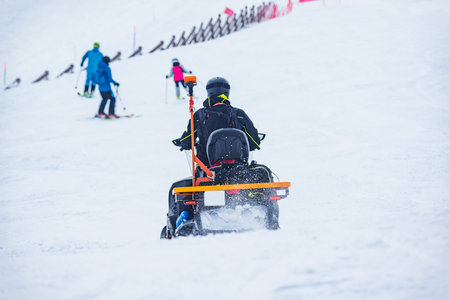 Rescuer man driving snowmobile on the ski resort.の写真素材