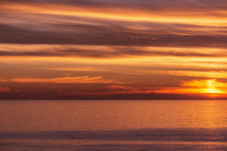 Amazing sunset sky above the sea surface.の写真素材