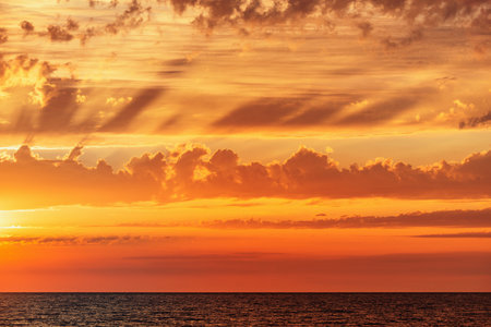 Amazing sunset sky above the sea surface.の写真素材