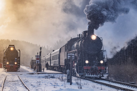 Retro steam train departs from the platform at winter morning.