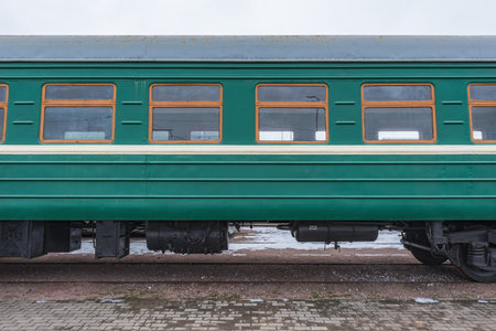 Retro passenger train carriage stands by the platform.の写真素材