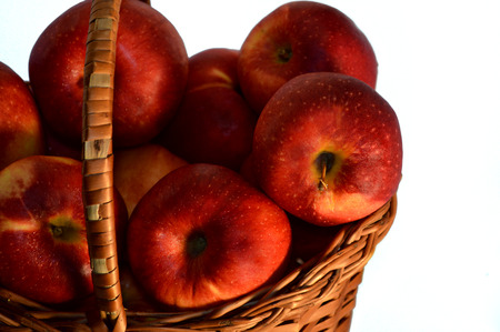apples in a wattled basket, close upの写真素材
