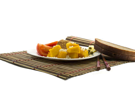 vegetarian food with bread, on a white plate and on a rugの写真素材