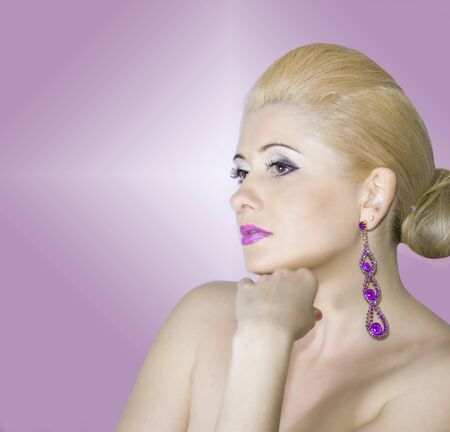 portrait of the face of the blonde on a pink backgroundの写真素材