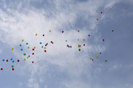 balloons in the sky against cloudsの写真素材