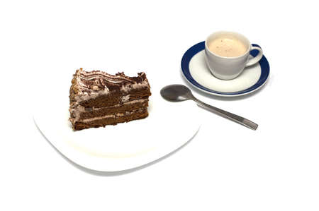 chocolate cake and mug of a cappuccino with a tea spoonの写真素材
