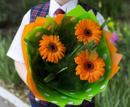 the school student with flowers, a close up, flowers in the centerの写真素材