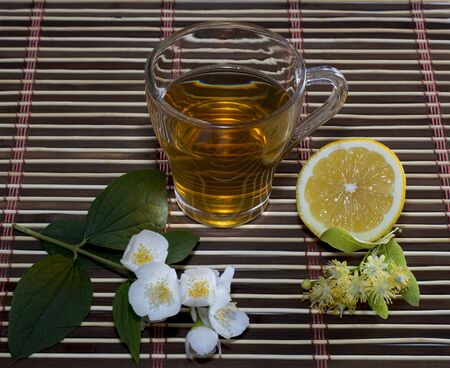 glass of tea from a linden with a lemon on a rugの写真素材