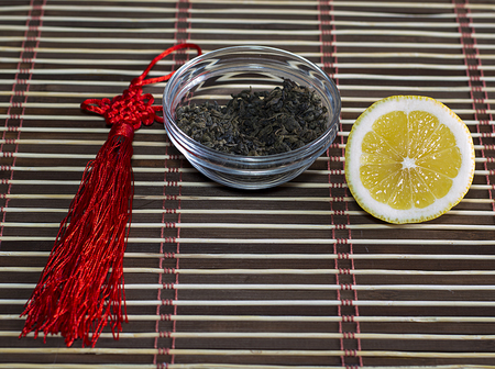 saucer with tea and a row a lemon, on a rugの写真素材