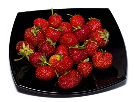 natural strawberry on a black plateの写真素材