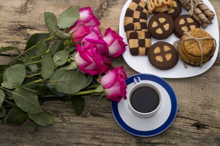 pink roses, coffee and cookies top viewの写真素材