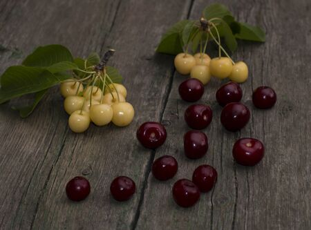 white and red sweet cherry on the old desktopの写真素材
