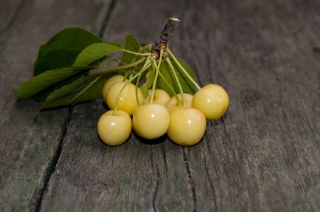 cluster of white sweet cherry on an old boardの写真素材