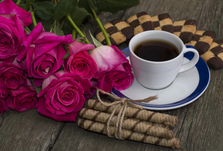 coffee with cookies and union of scarlet rosesの写真素材