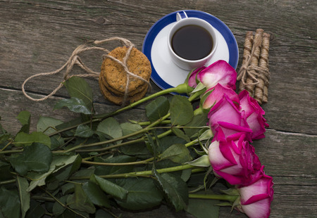 big bouquet of pink roses and cup of coffee, top viewの写真素材
