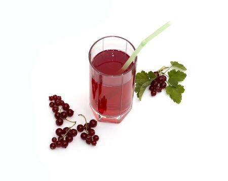 the glass of juice decorated with currant branchesの写真素材