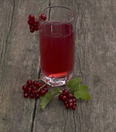 the glass of juice decorated with red currantの写真素材