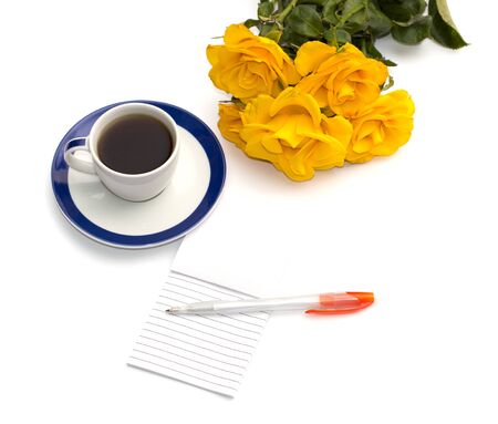 cup of coffee, yellow roses and notebook with the handleの写真素材