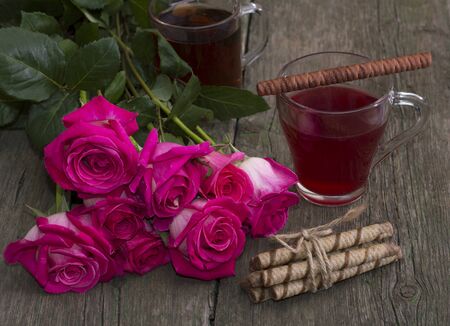 red roses and two glasses of teaの写真素材